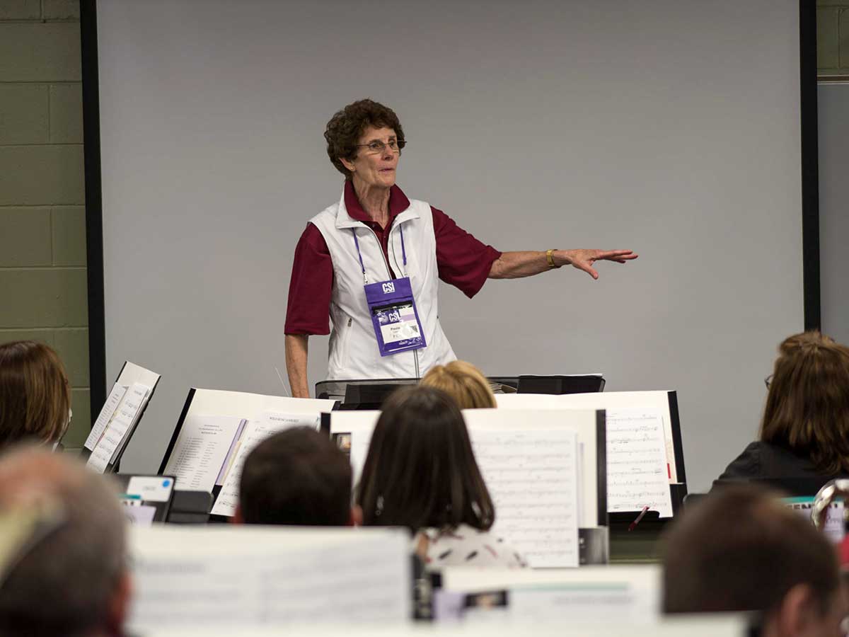 Paula Crider helping conduct a music reading session.